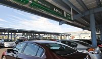 a group of cars parked under a canopy