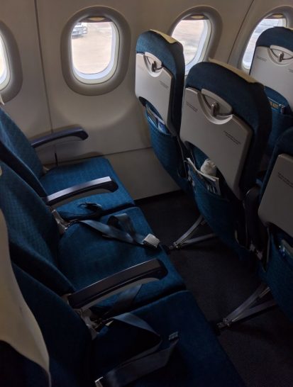 a row of blue seats in an airplane
