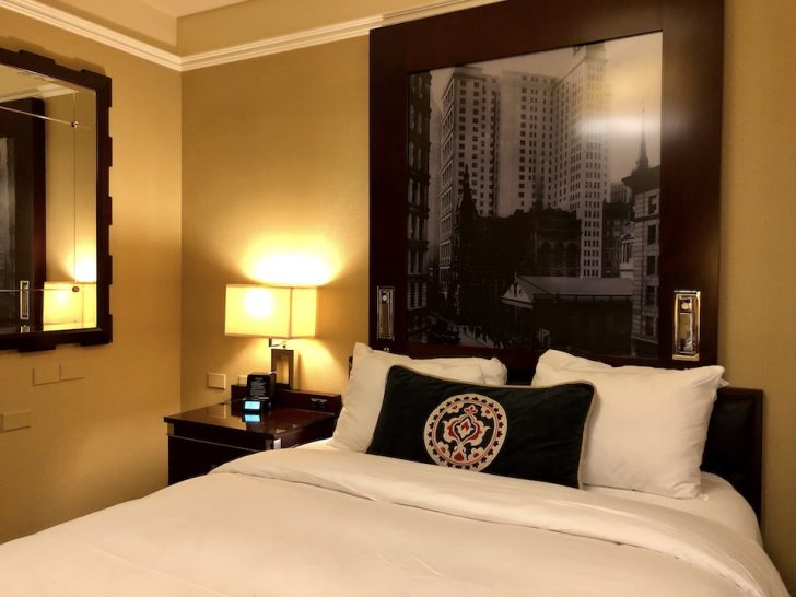 a bed with a picture on the wall