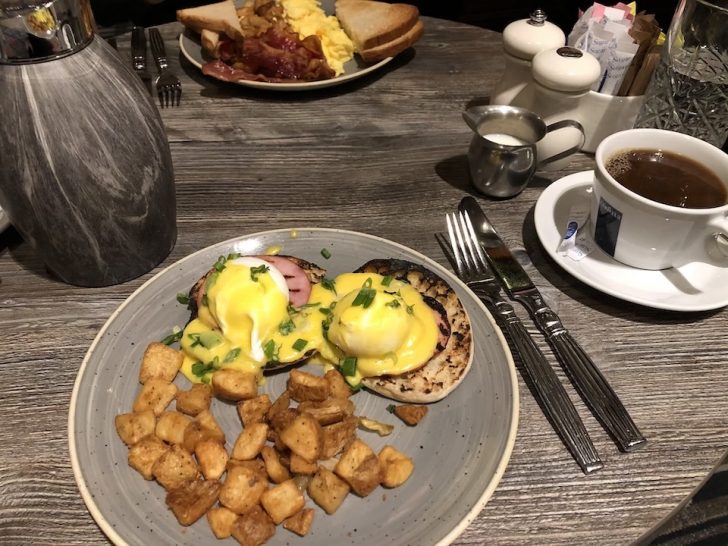 a plate of food and a cup of coffee