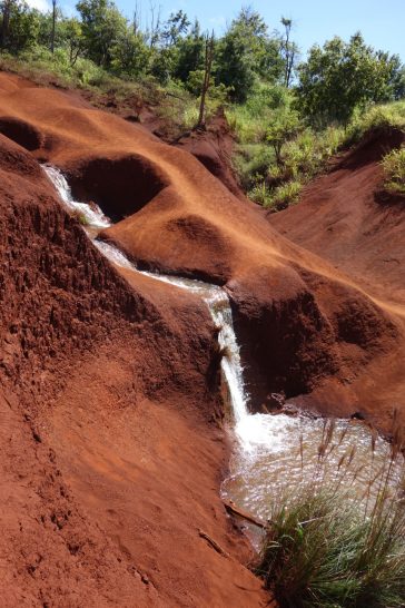 a small waterfall in a red hill