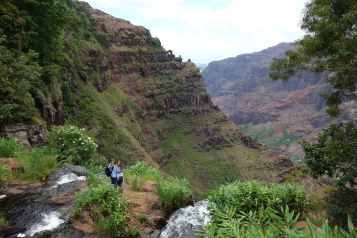 a couple standing on a rocky cliff