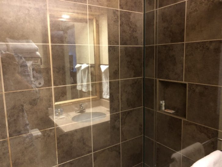 a bathroom with a glass shower door