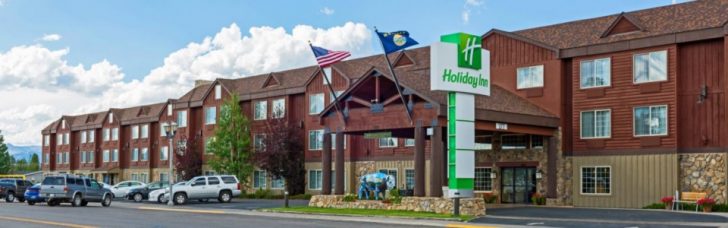 a hotel with flags in front of it