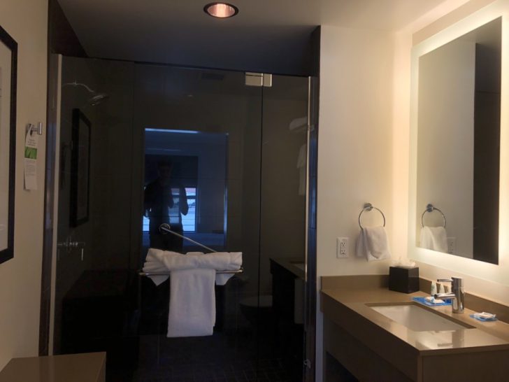 a bathroom with a glass shower door