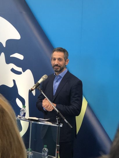 a man standing at a podium with a microphone