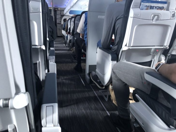 people sitting on the seats of an airplane