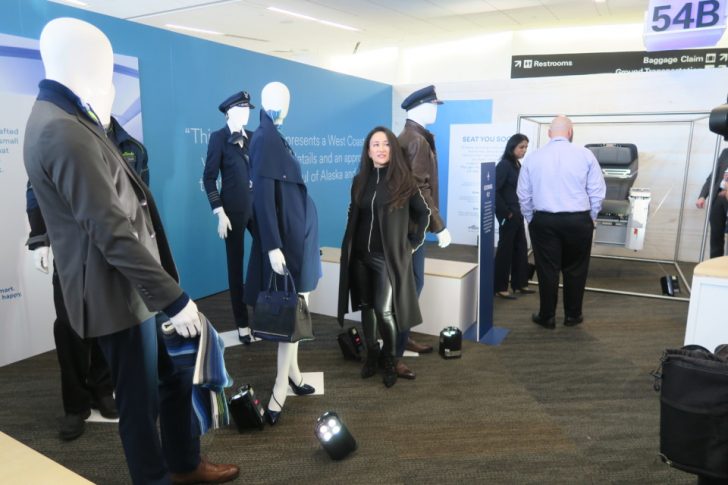 a woman standing in a room with mannequins