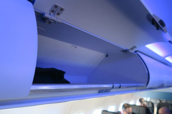 an airplane shelf with a shelf open