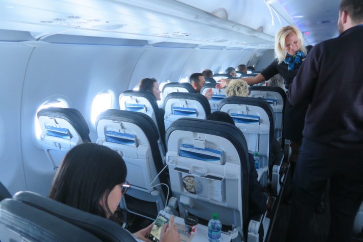 a woman standing in an airplane