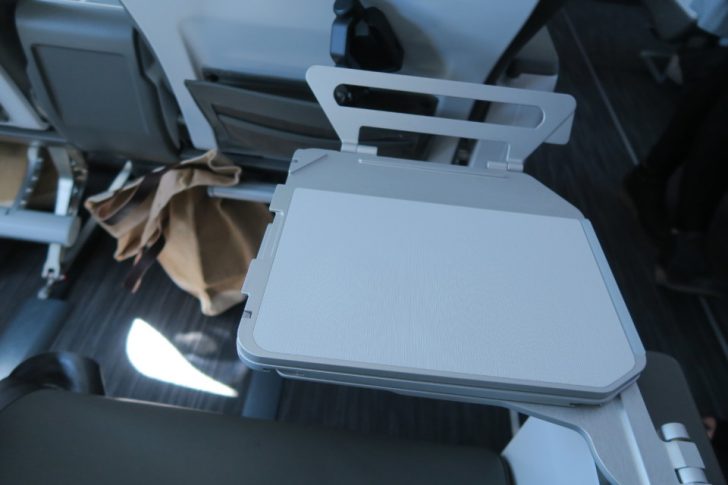 a white rectangular object with a black handle