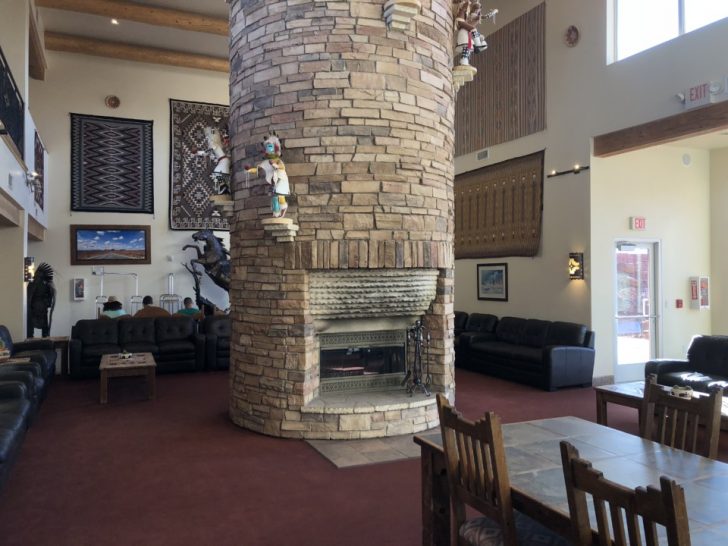 a large stone pillar in a room with a couches and a table
