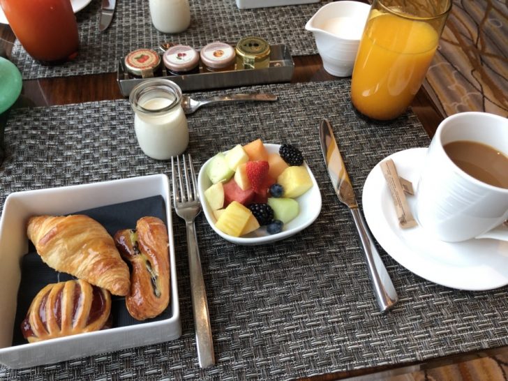a plate of food and a cup of coffee