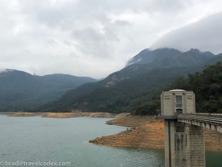 a bridge over a body of water with mountains in the background