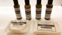 a group of bottles of body soap and a bar of soap