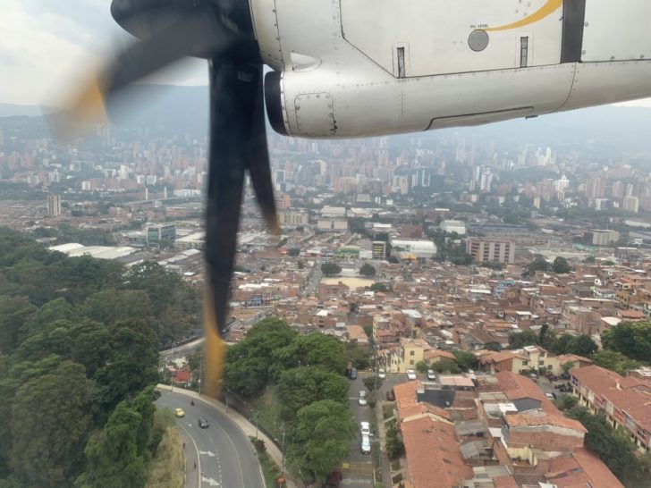 a propeller of a plane flying over a city