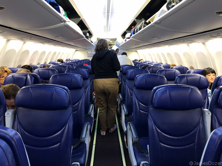 a woman walking in an airplane