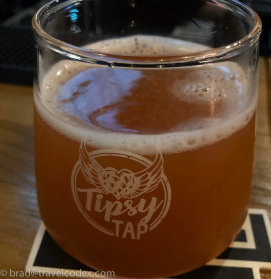 a glass of beer on a coaster