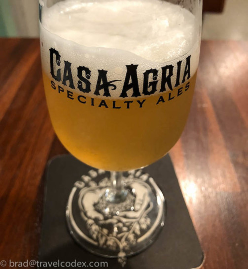 a glass of beer on a coaster