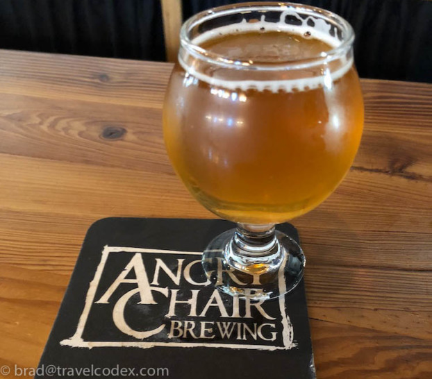 a glass of beer on a coaster