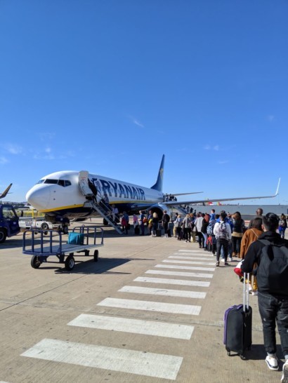a group of people standing in line to a plane
