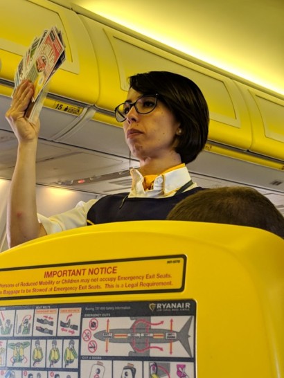 a woman reading a newspaper on an airplane