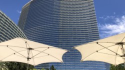 a large building with white umbrellas