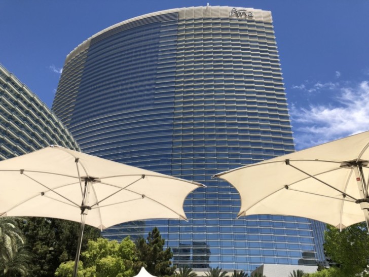 a tall building with white umbrellas