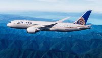 a plane flying over mountains