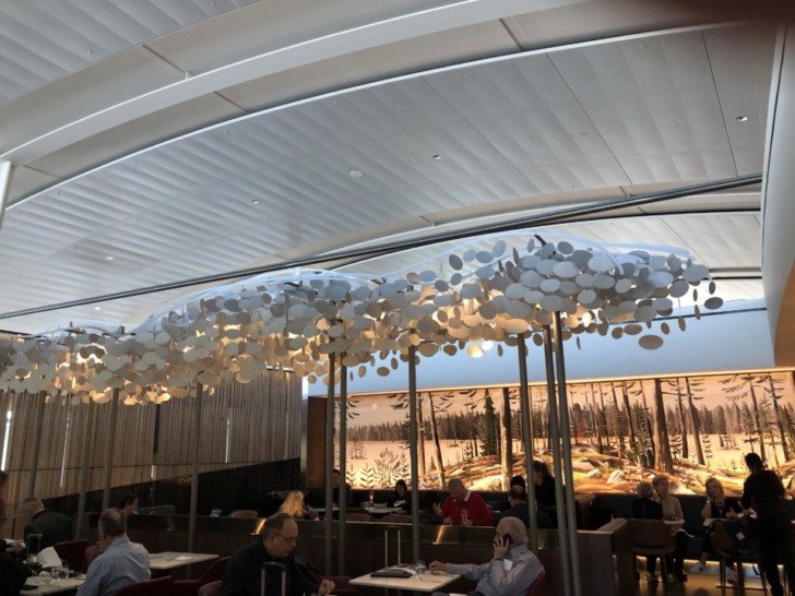 a group of people sitting at tables in a restaurant