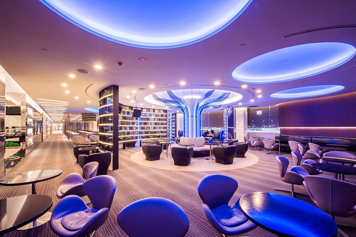 a room with blue lights and chairs