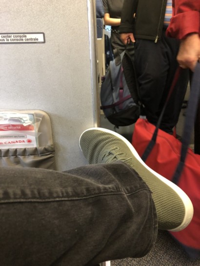 a person's leg and shoe on a plane