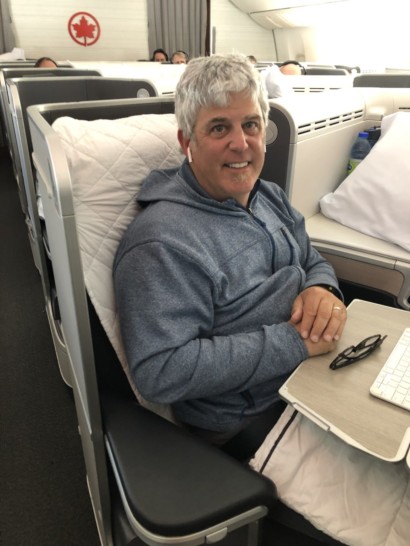 a man sitting in a chair with a laptop