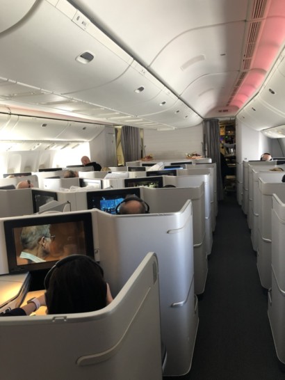 a group of people sitting in chairs in an airplane