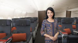 a woman standing in an airplane