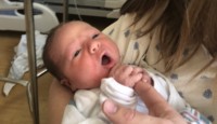 a baby being held by a person