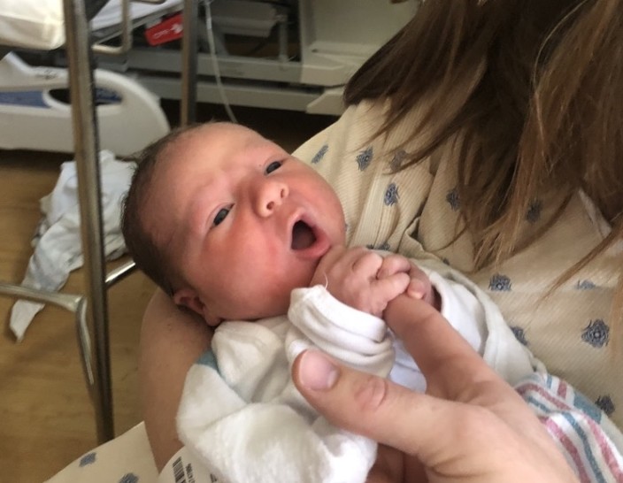 a baby being held by a person