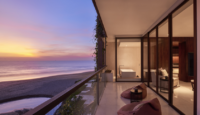 a balcony with a view of the ocean and a beach