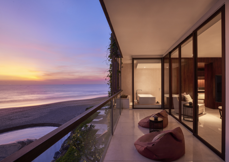 a balcony with a view of the ocean and a beach