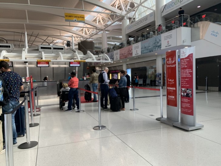people standing in a line at an airport