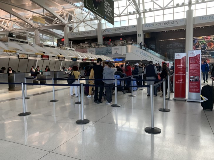 people standing in a line at an airport