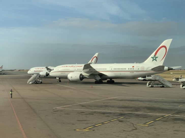 a group of white airplanes on a tarmac