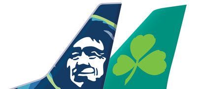 a blue and green airplane tail fin with a face and a green clover