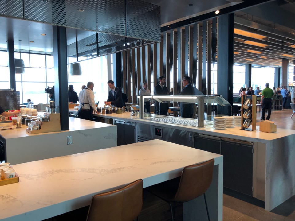 people standing around a counter in a room