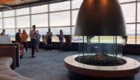 a group of people in a room with a fireplace