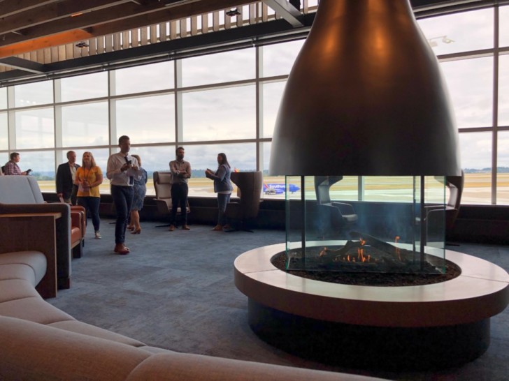 a group of people in a room with a fireplace