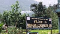 a sign in front of a mountain