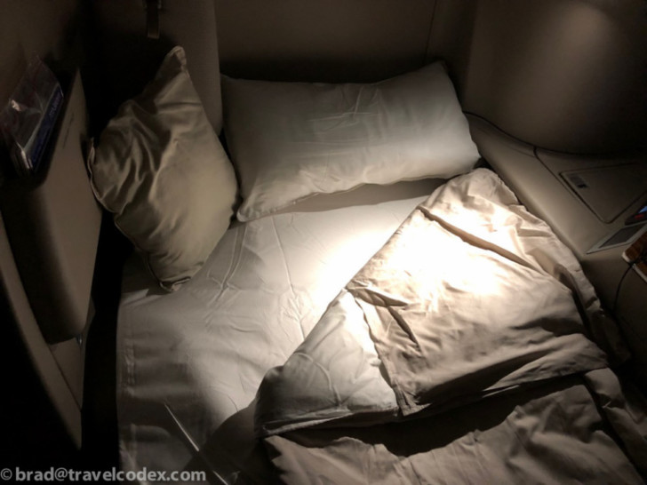 a bed with pillows and a pillow on it
