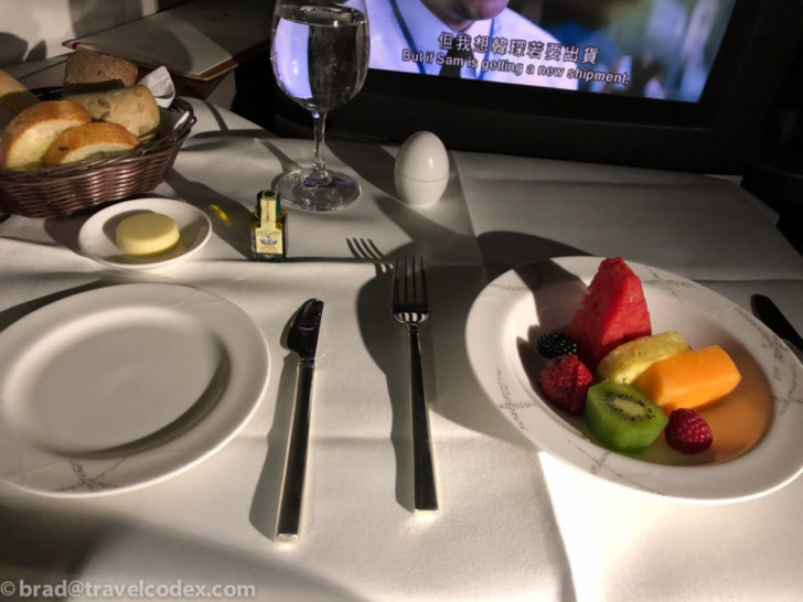 a plate of fruit and a fork on a table