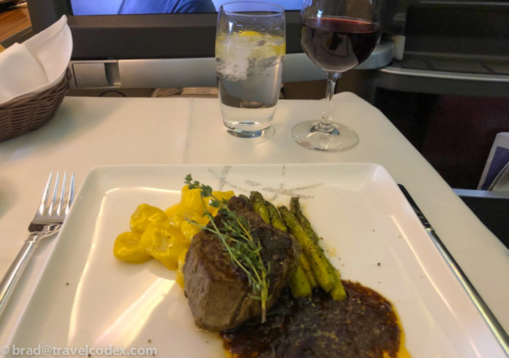a plate of food and a glass of wine